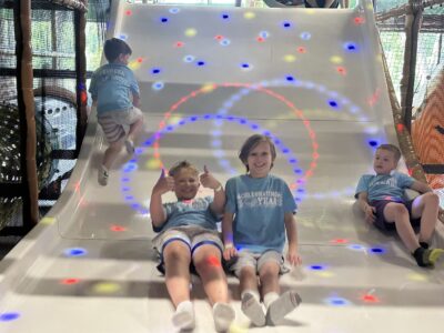 school age boys on slide