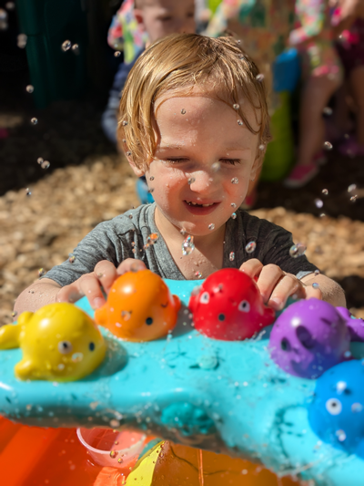 toddler playing with water toys
