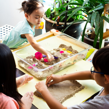 kids playing with sand table