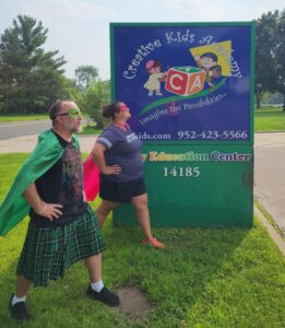 staff in superhero costumes