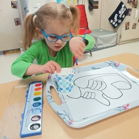 Preschooler painting with watercolors