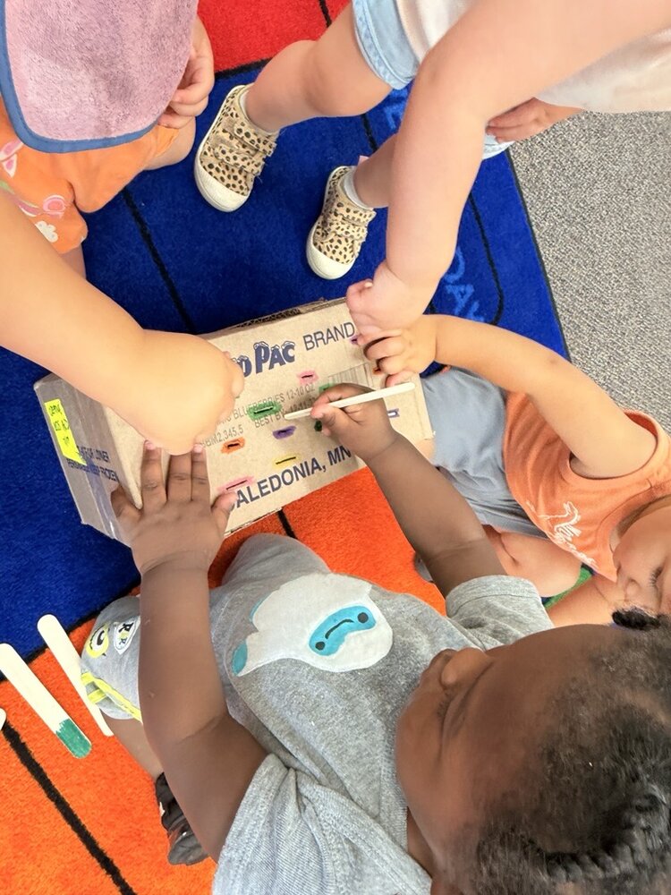 Toddlers working together on a group activity