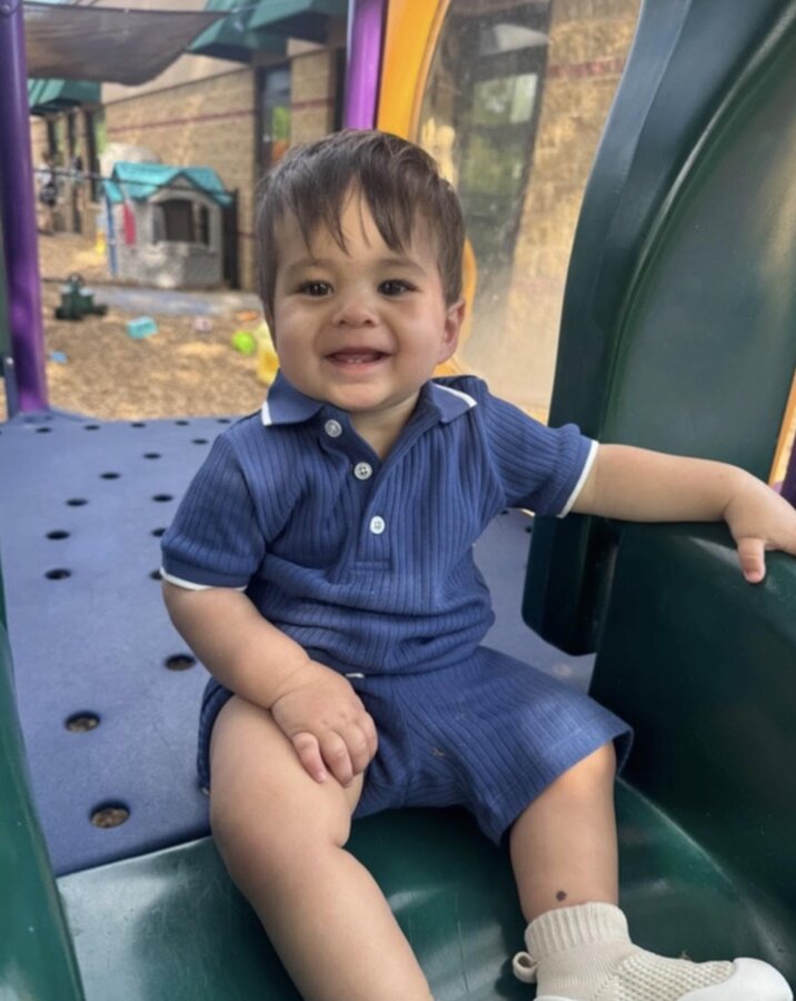 Staying connected throughout the day Toddler smiling on the playground at Creative Kids Academy