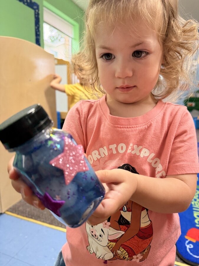 Toddler exploring a sensory discovery bottle