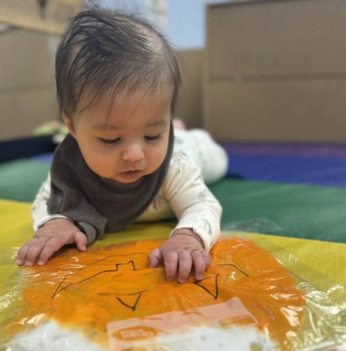 Baby enjoying tummy time at Creative Kids Academy