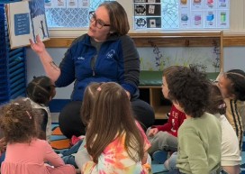 Teacher reading a story to preschoolers during circle time