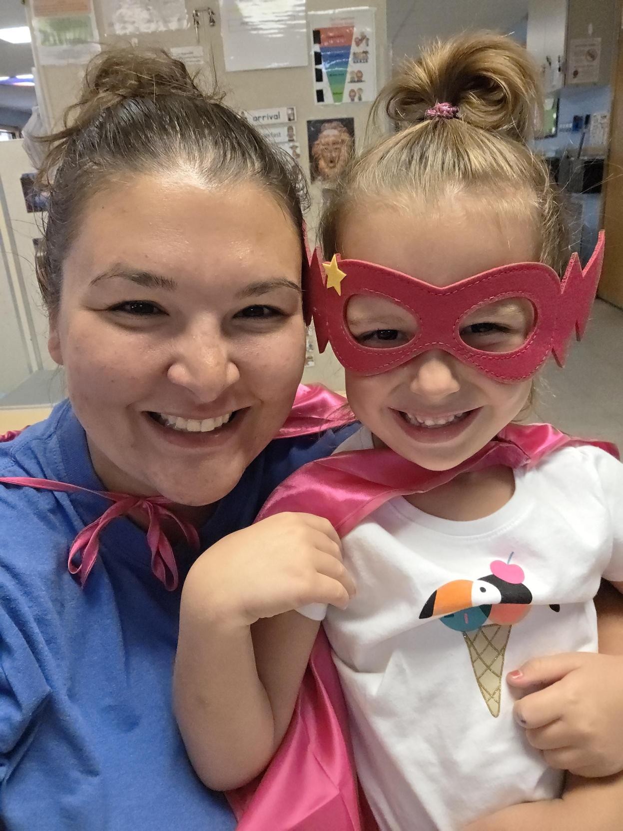 Teacher and preschoolers dressed as superheroes at Creative Kids Academy