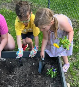 Preschoolers gardening together at Creative Kids Academy