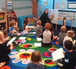 Preschoolers practicing early writing skills during circle time