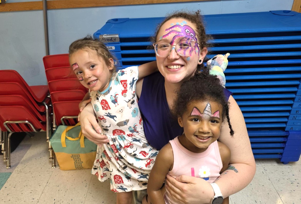 Teacher and preschoolers smiling with face paint at Creative Kids Academy
