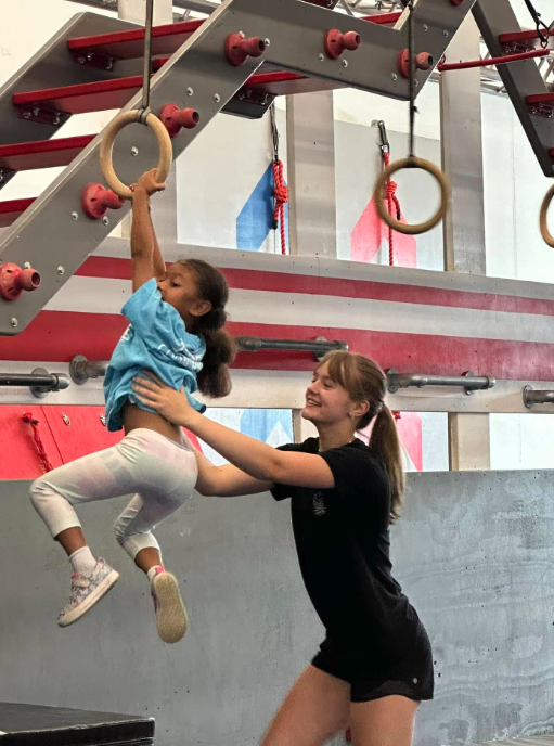 School-age child on gym rings