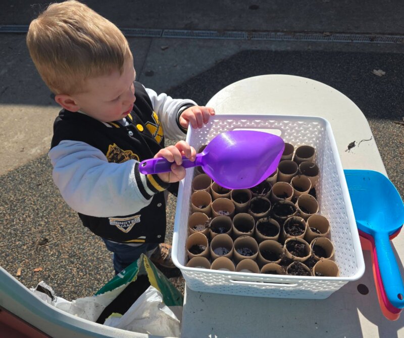 Toddler practicing scooping and pouring