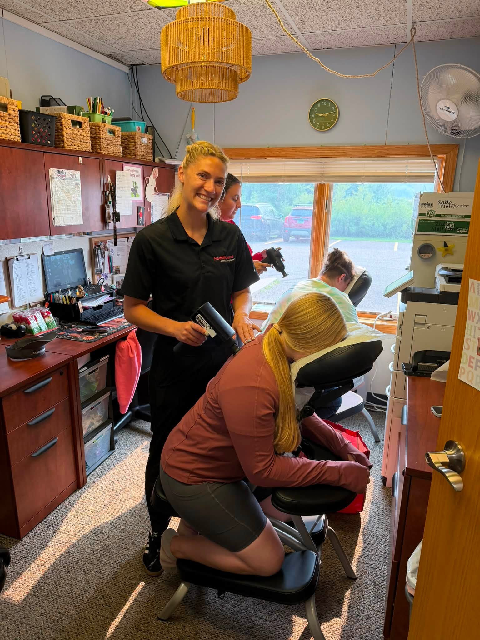 CKA staff member enjoying a wellness chair massage