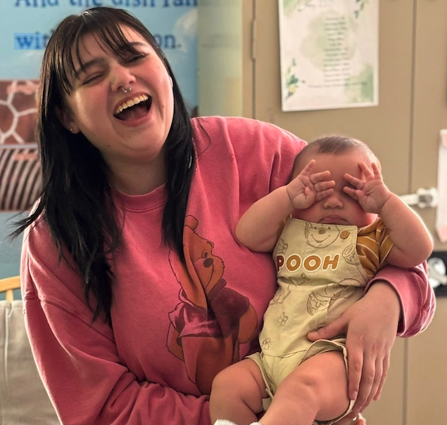 Teacher laughing with a happy baby at CKA