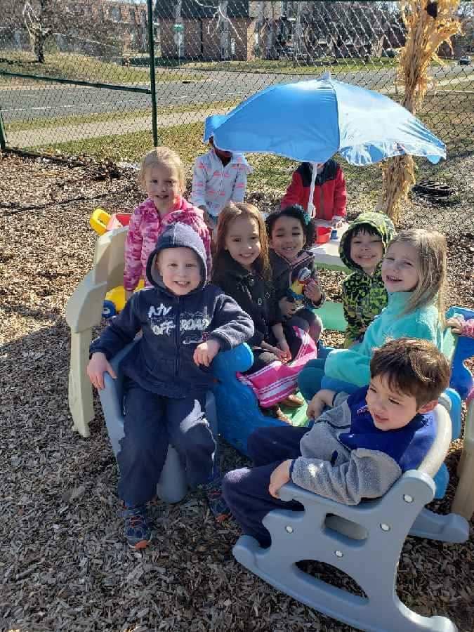 Children gathered together on the playground for outdoor play