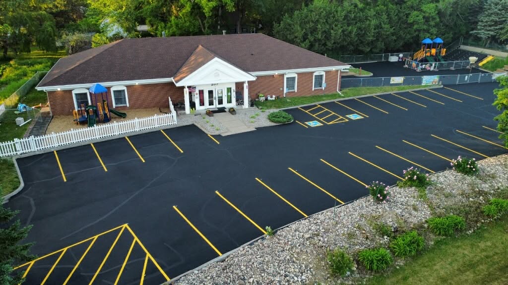 Aerial view of the Creative Kids Academy Maplewood building, parking lot, and playground