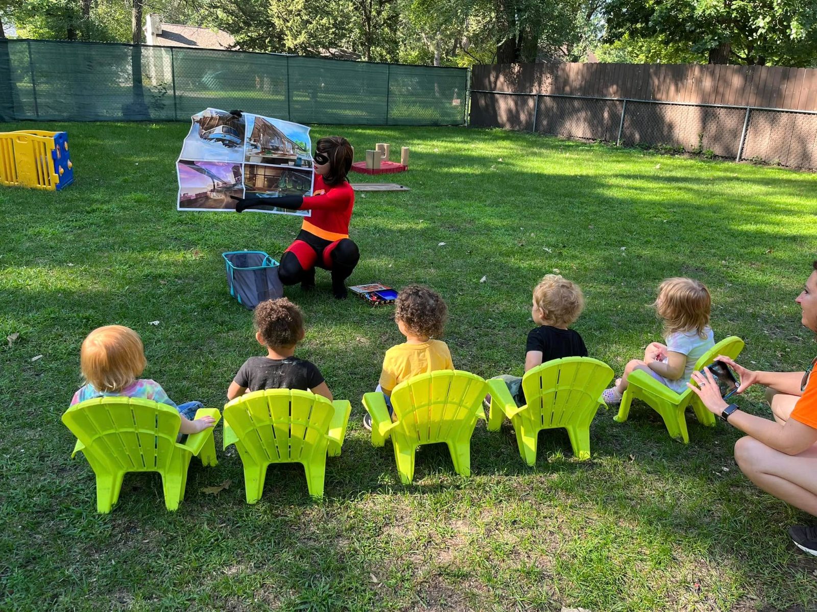 Costumed performer leading storytime outside at Creative Kids Academy Coon Rapids