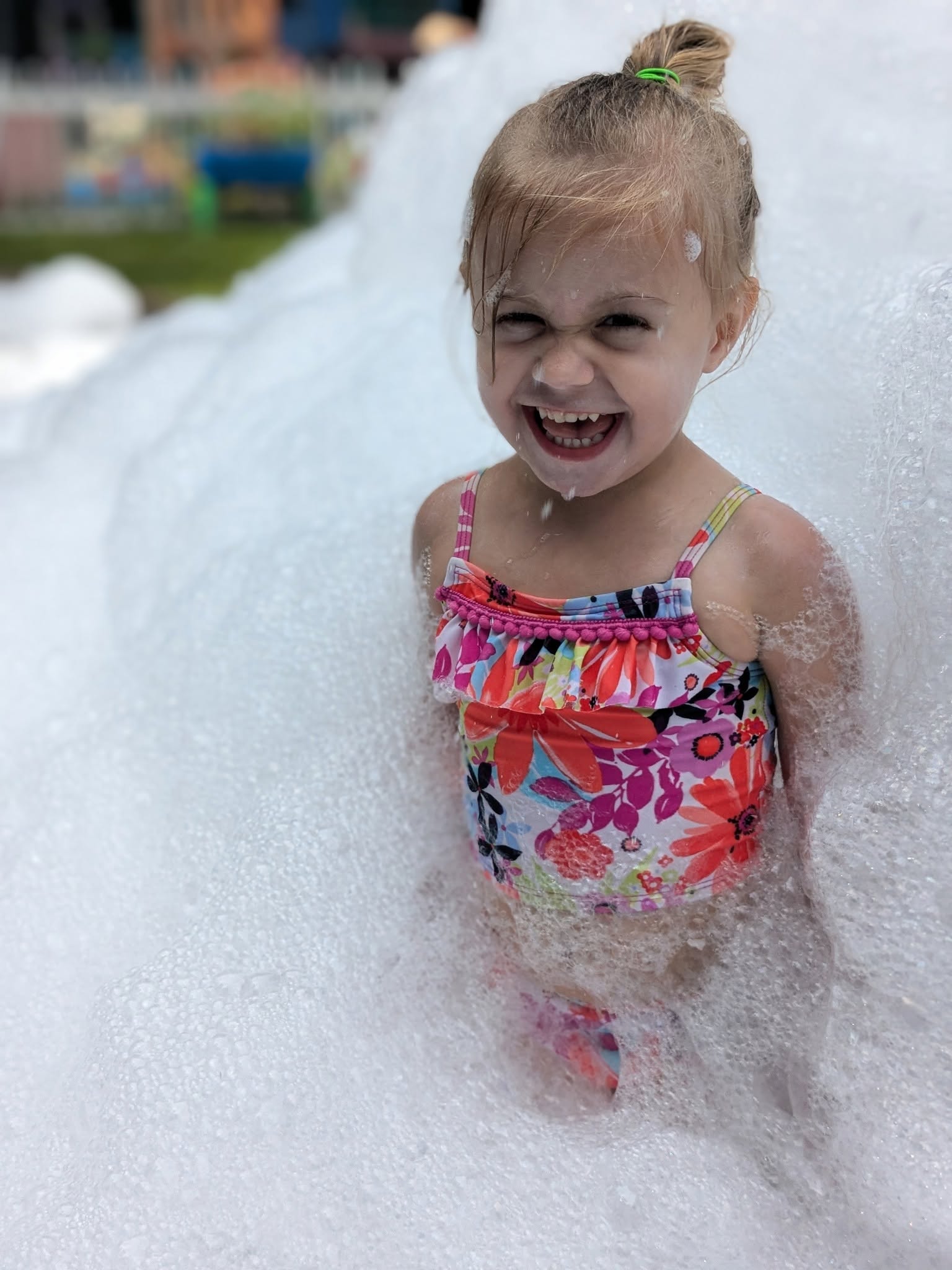 A preschooler enjoying a joyful foam party at Creative Kids Academy Maple Grove