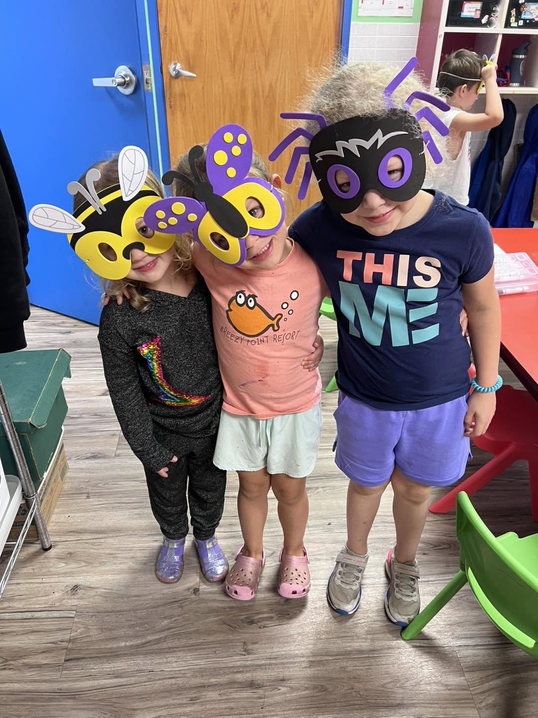 Preschoolers wearing bee and butterfly masks for a creative dress-up activity at Creative Kids Academy Zimmerman
