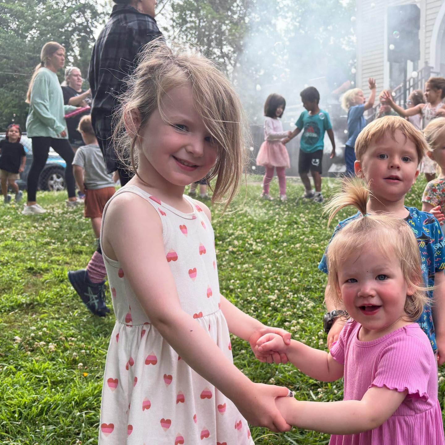 Children playing outdoors with bubbles at Creative Kids Academy Orono