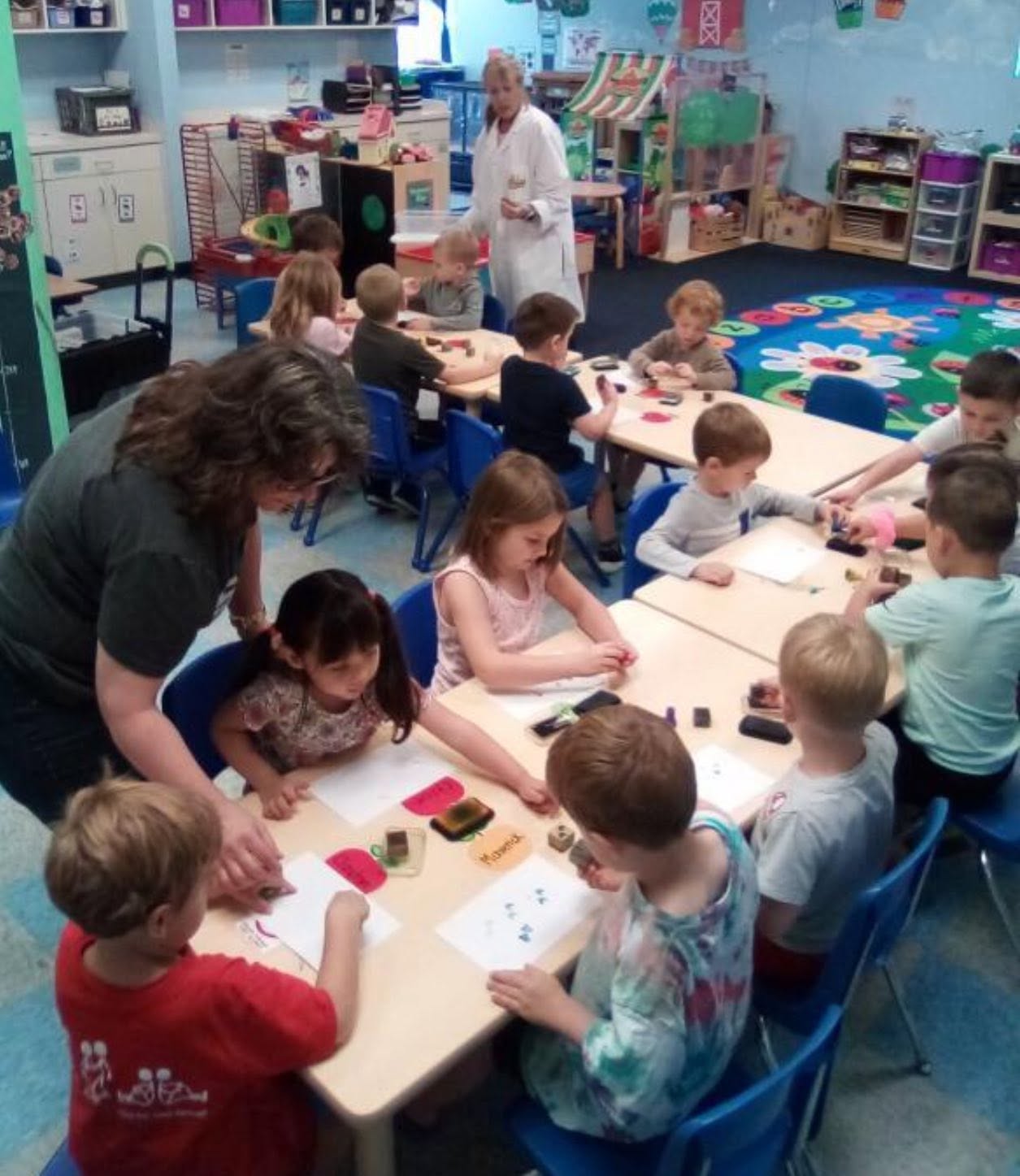 Preschoolers exploring a hands-on science experiment at Creative Kids Academy Centerville