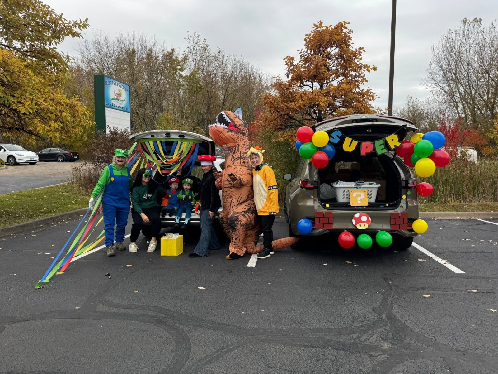Families enjoying a costume trunk-or-treat celebration at Creative Kids Academy Centerville