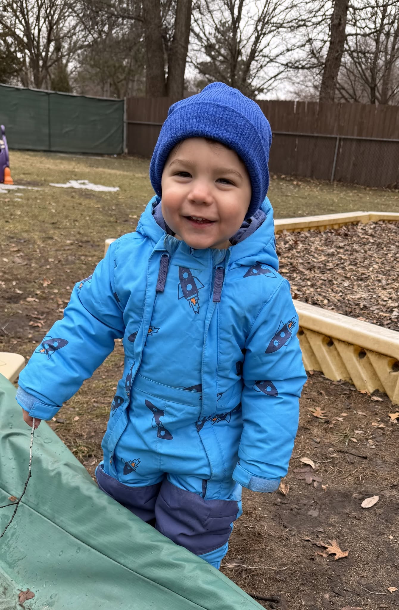 Toddler painting at the outdoor art table