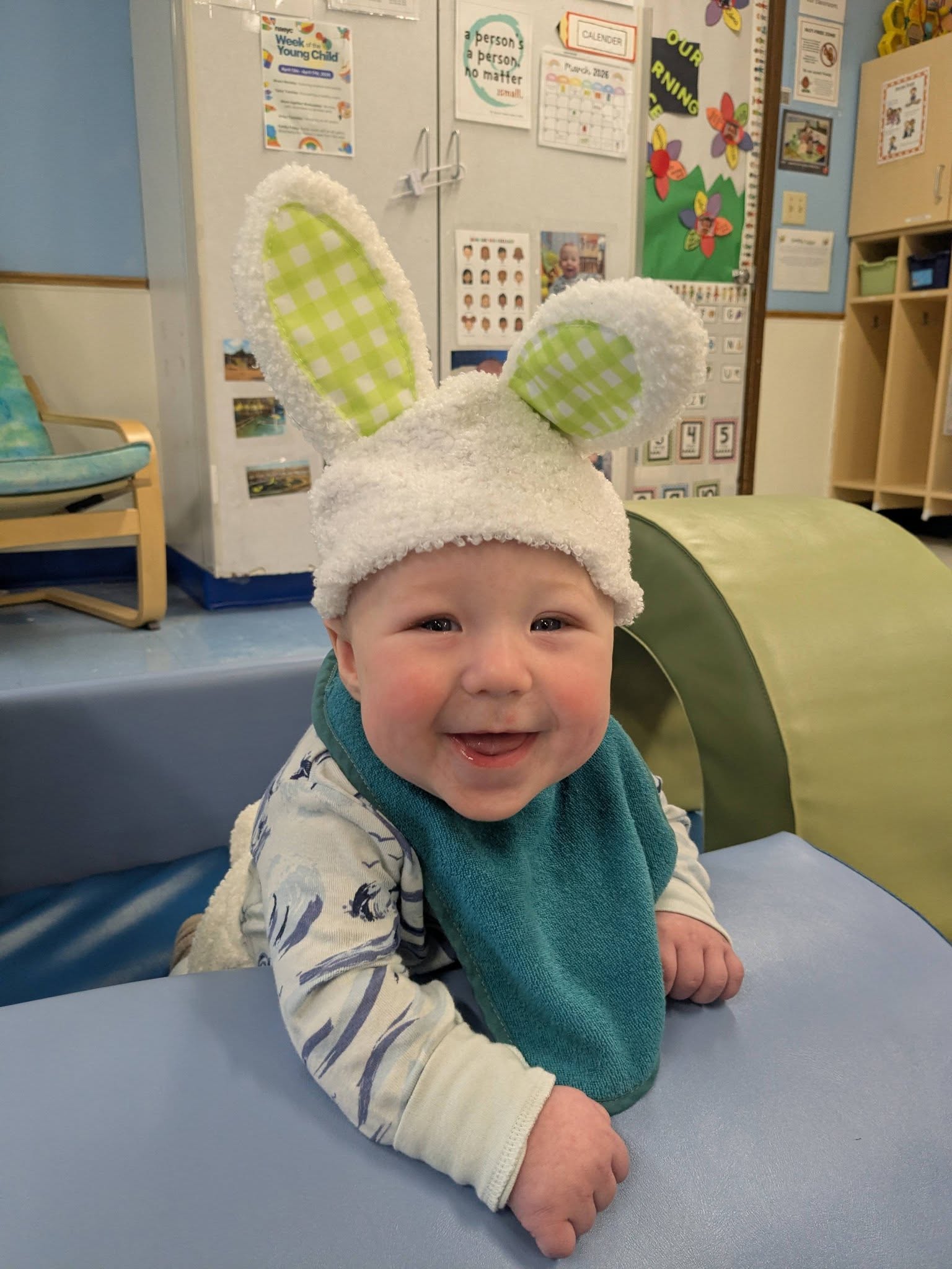 A baby wearing bunny ears for a springtime celebration at Creative Kids Academy Maple Grove