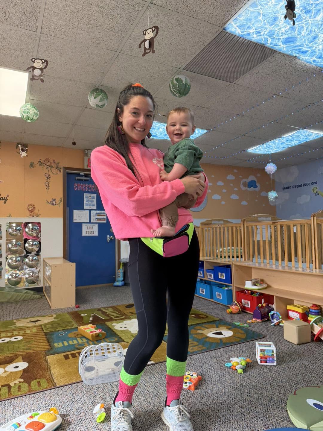 A teacher holding an infant