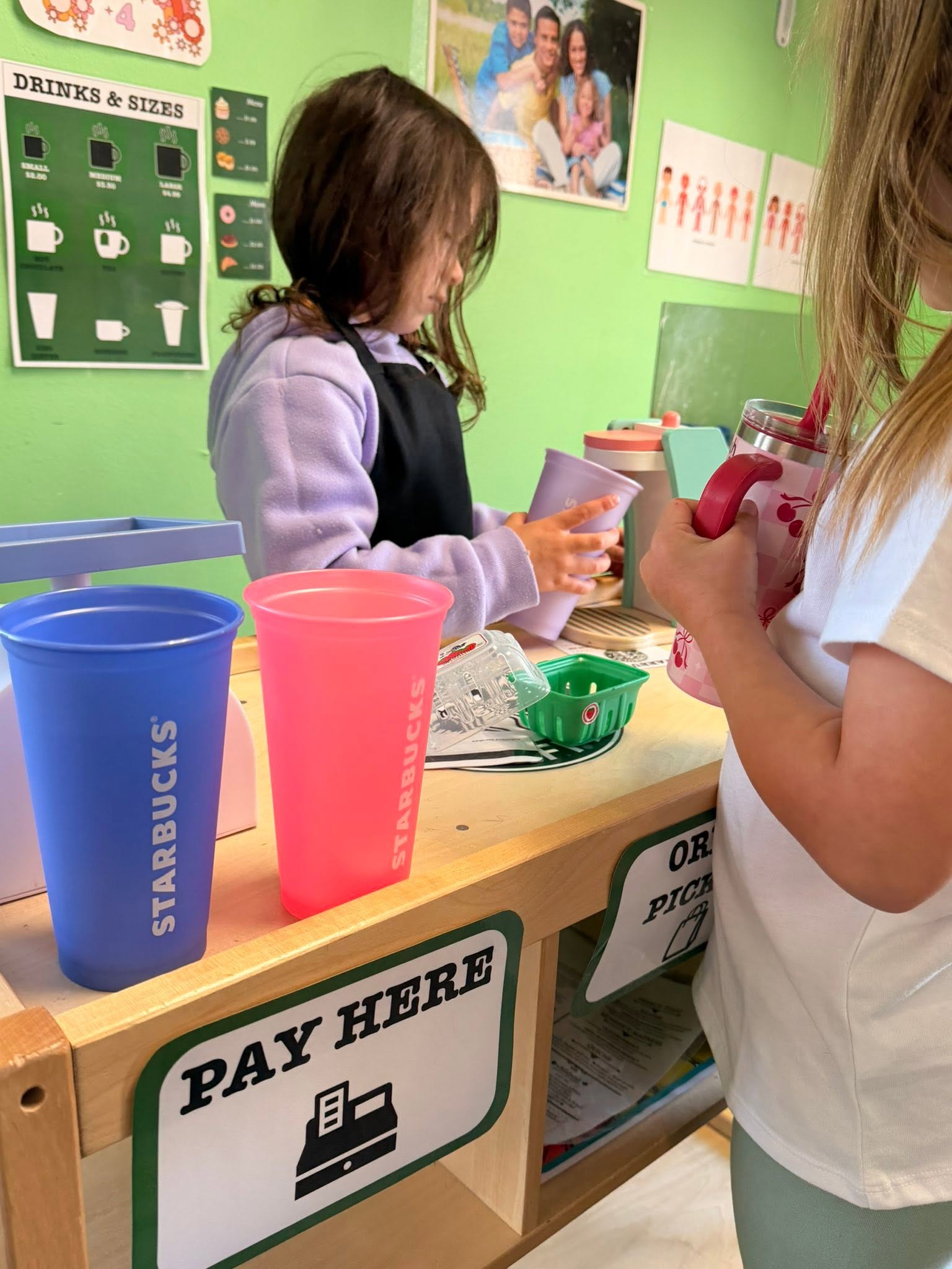 Preschoolers running their pretend coffee shop