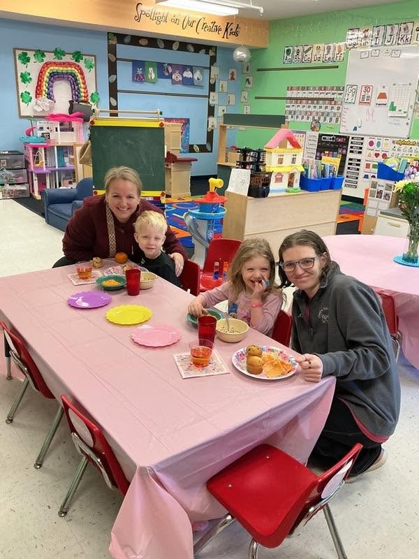 A teacher and children enjoying a table-time activity together at Creative Kids Academy Lexington