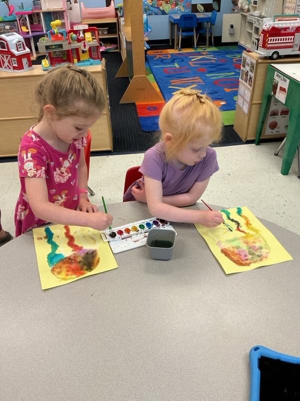 Two children painting together at the art table at Creative Kids Academy Lexington