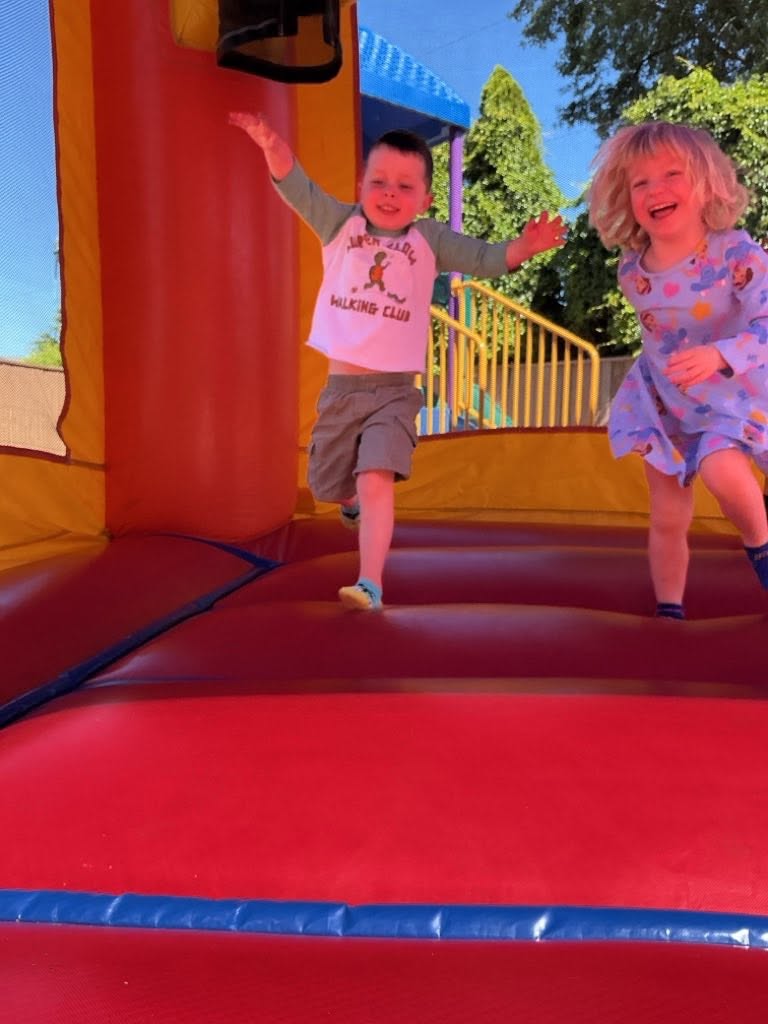 Children playing and laughing in a bounce house at Creative Kids Academy Lexington