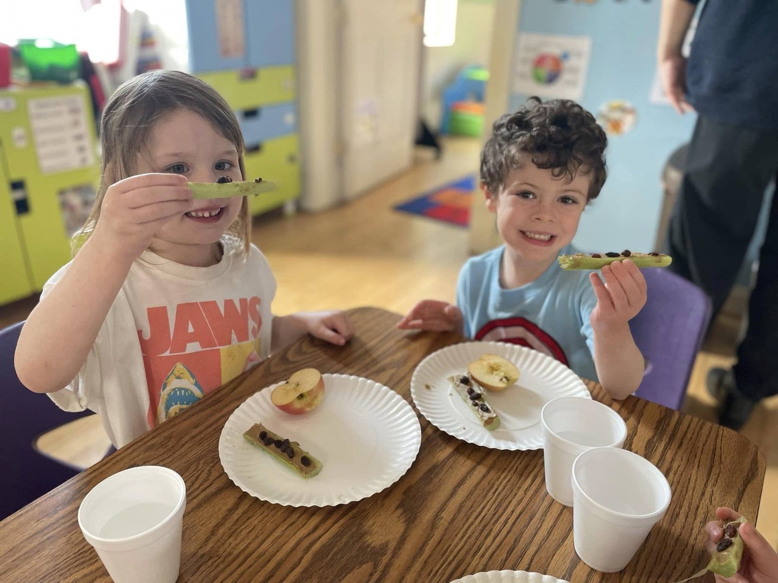 Children enjoying a fresh snack together at a Creative Kids Academy center