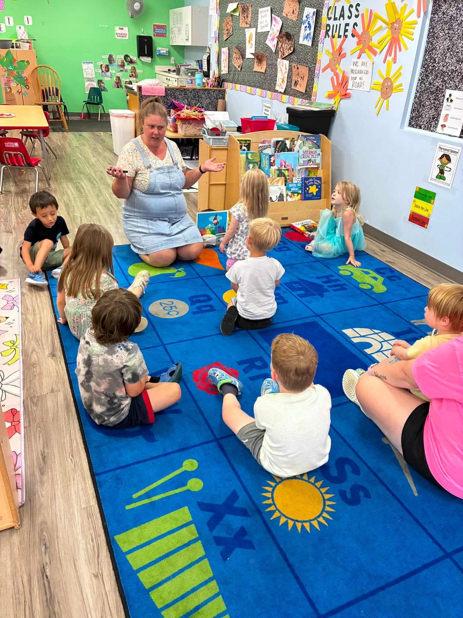Teacher leading circle time with preschoolers at Creative Kids Academy Elk River
