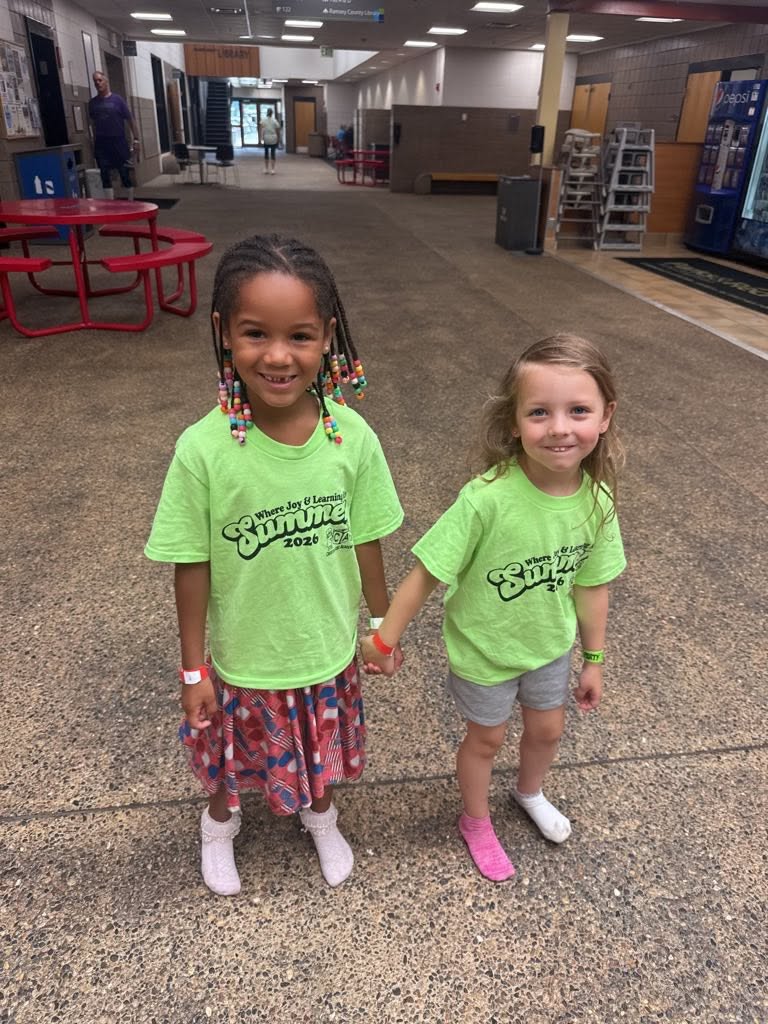 Two preschool friends holding hands on a summer field trip at Creative Kids Academy Lexington