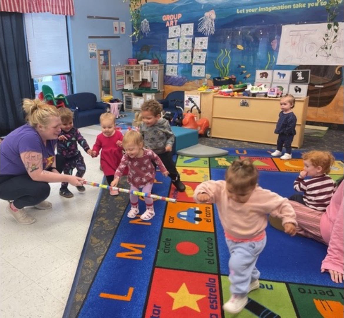CKA toddlers moving and dancing with their teacher during a Dancercise class