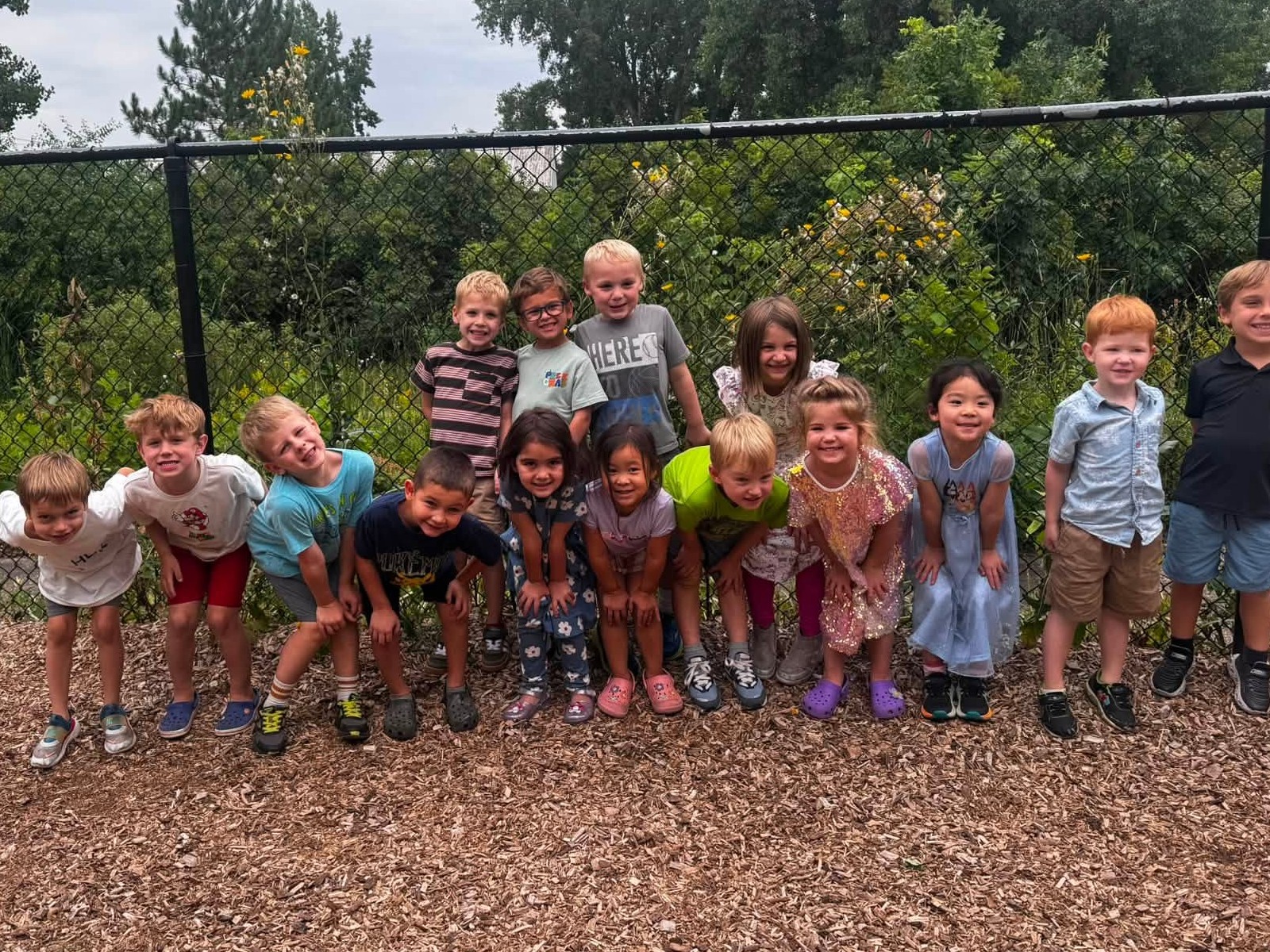 A preschool class lined up together on the playground at Creative Kids Academy